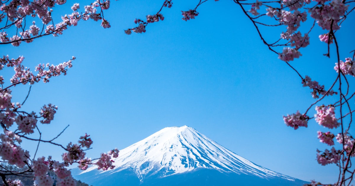 Mount Fuji reflected in calm lake with snow-capped peak Japan