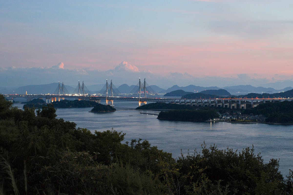 Suspension bridge crossing the Seto Inland Sea between green islands
