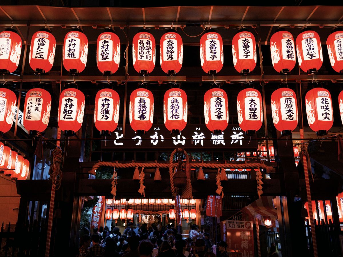 Colorful Japanese lanterns illuminating a bustling street festival at night, evoking the Aomori Nebuta Festival