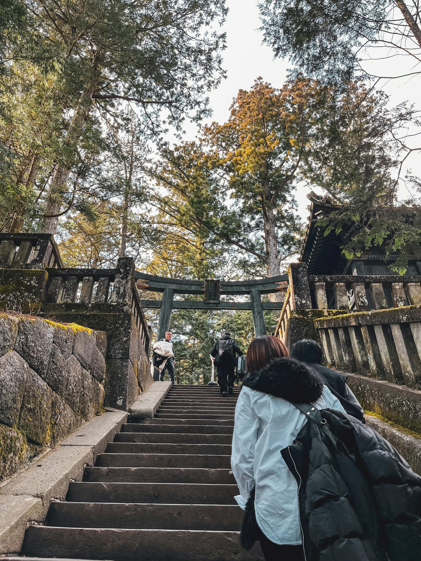 Visitors climbing the long stone staircase to Konpira-san shrine in Kotohira, Shikoku