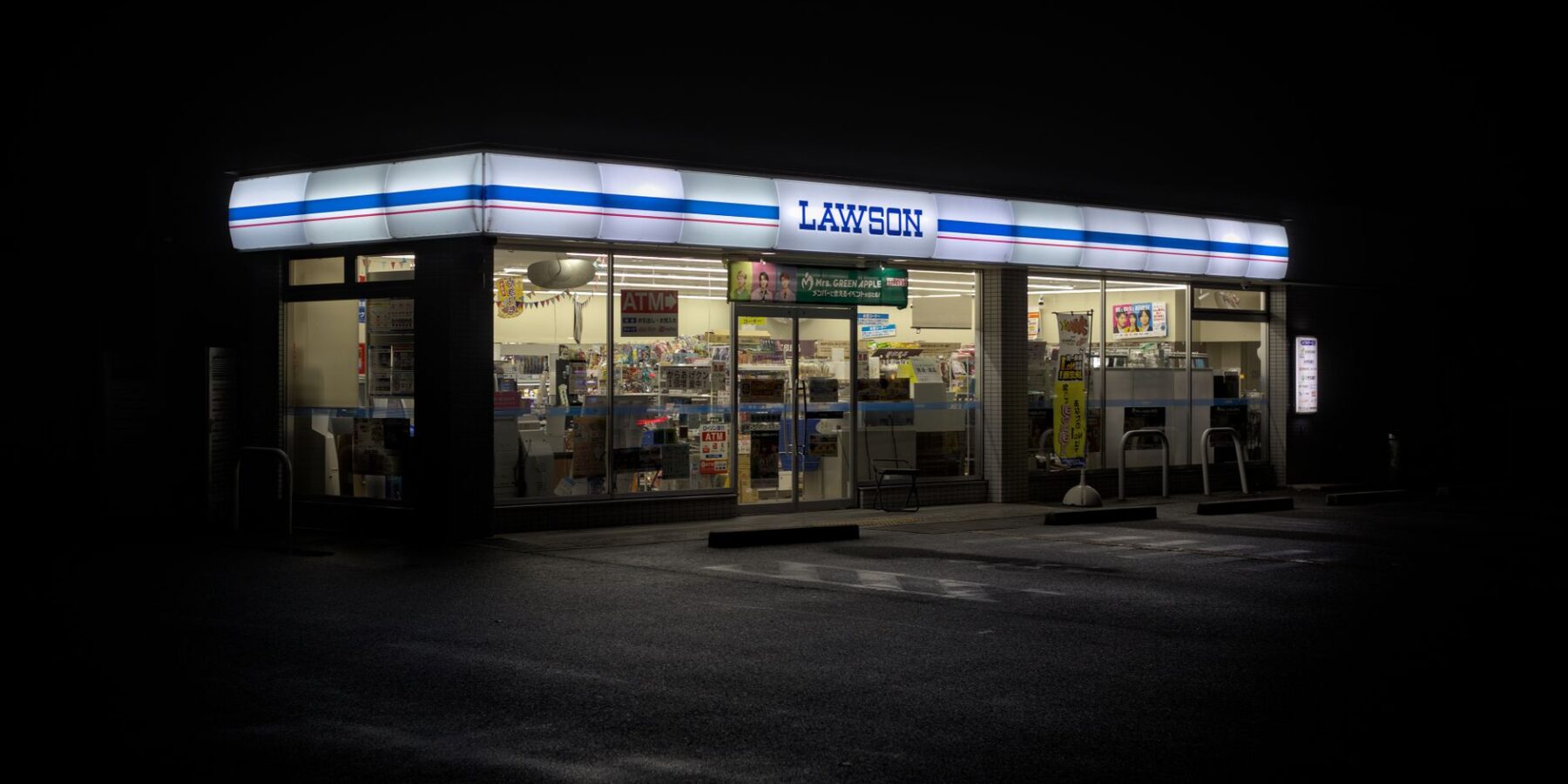 A brightly lit Japanese convenience store at night