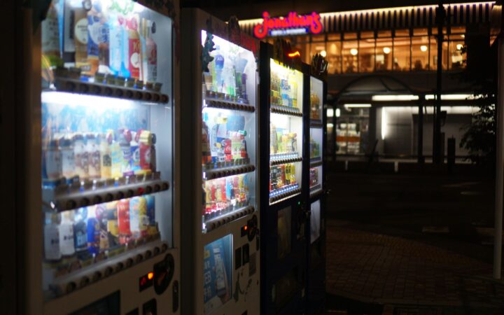 Glowing Japanese vending machines on a street at night