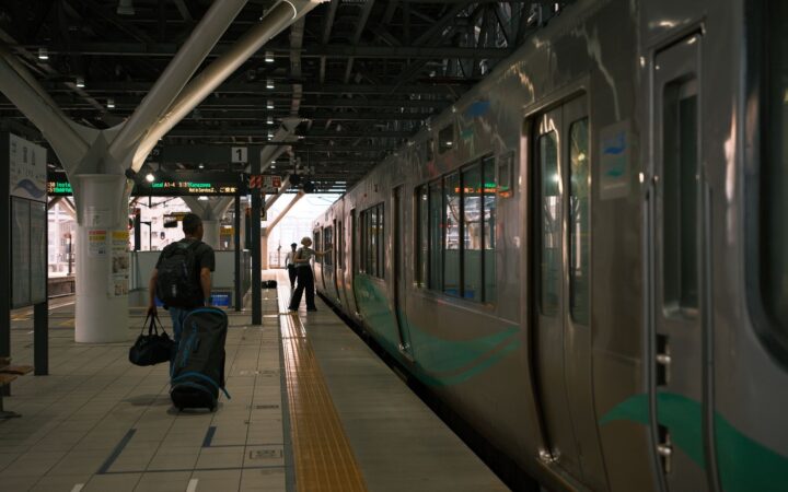 A traveler with a suitcase at a Japanese train station