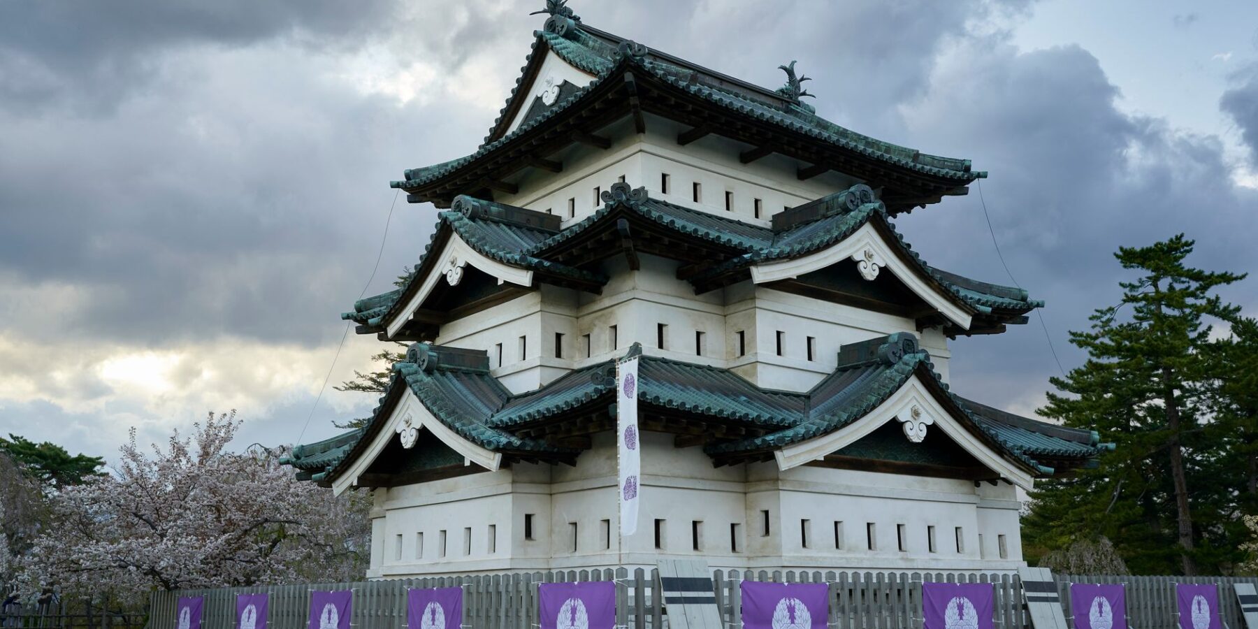 Hirosaki Castle keep with cherry blossoms in Hirosaki, Aomori