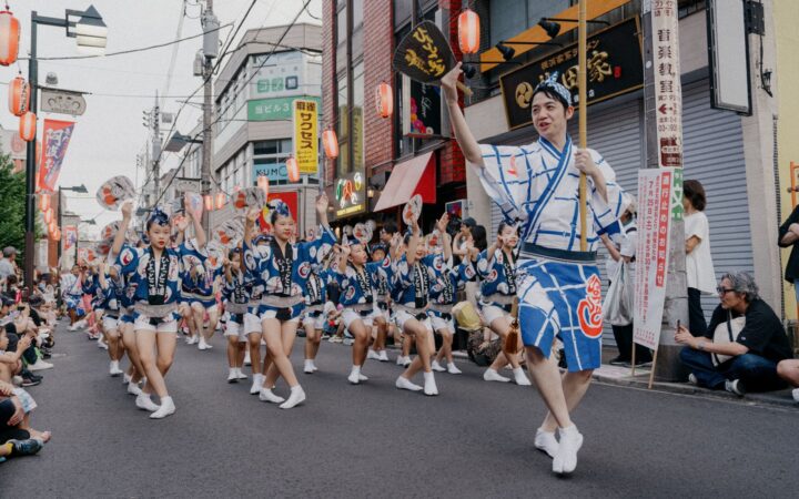 Awa Odori dancers in matching happi coats performing in a street parade