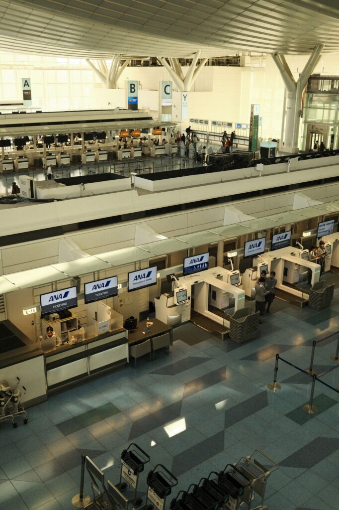 Rows of airline check-in counters in the departure hall at Haneda Airport, Tokyo