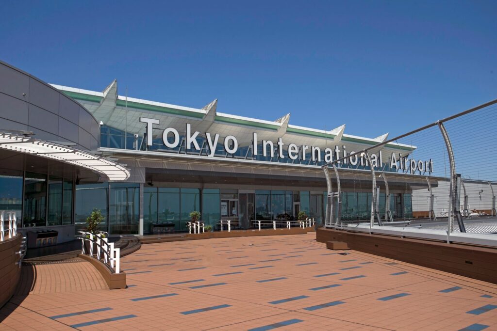 The Tokyo International Airport (Haneda) sign above the terminal's open-air observation deck