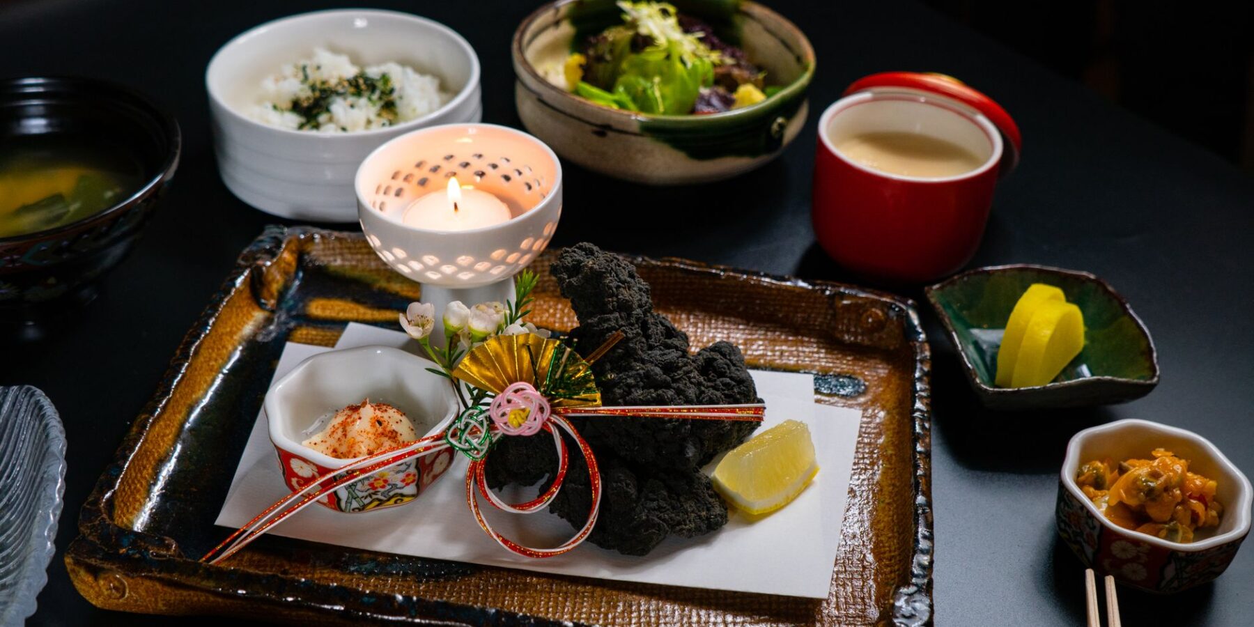 Japanese multi-course meal of small seasonal dishes on a lacquer tray
