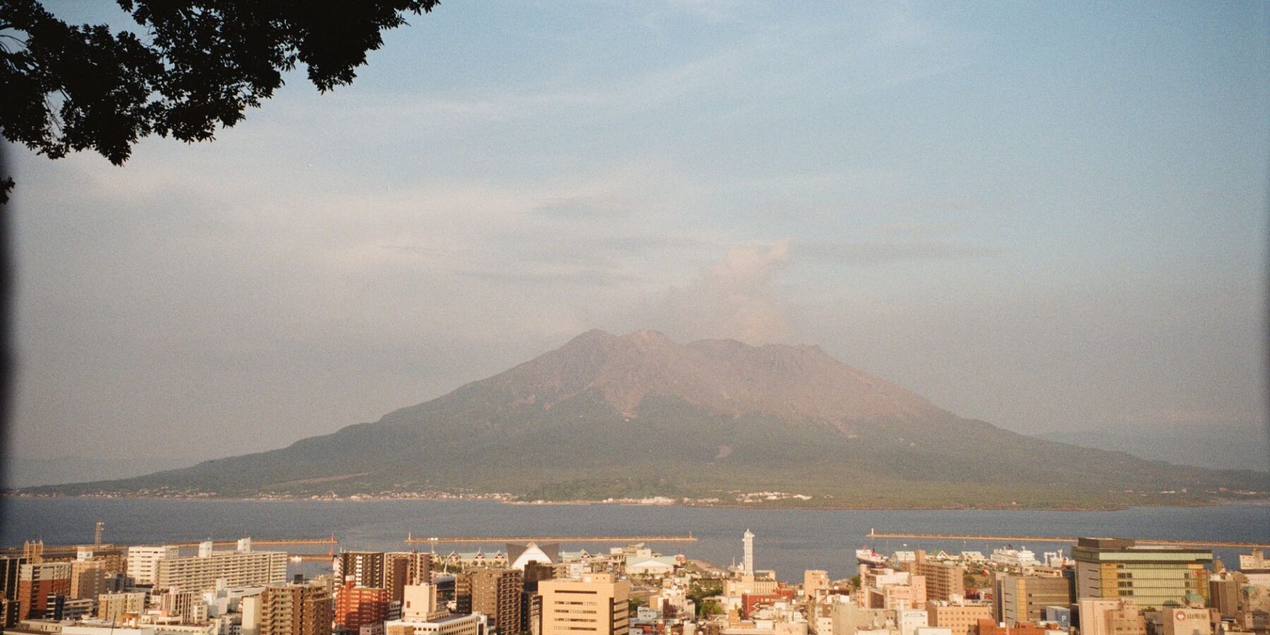 Sakurajima volcano rising across the bay behind Kagoshima city, Japan