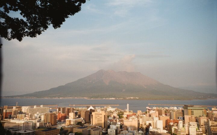 Sakurajima volcano rising across the bay behind Kagoshima city, Japan