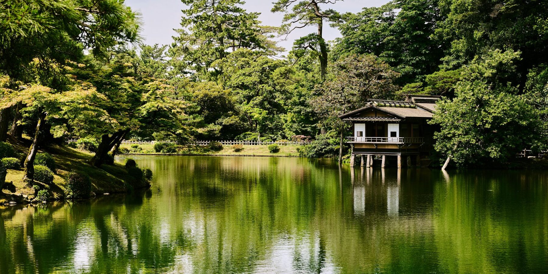 Kenrokuen Garden pond with a teahouse and pine trees in Kanazawa, Ishikawa, Japan