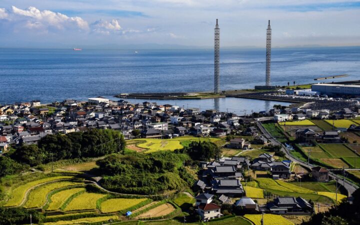 Aerial view of a seaside village with rice terraces on the coast of Karatsu, Saga