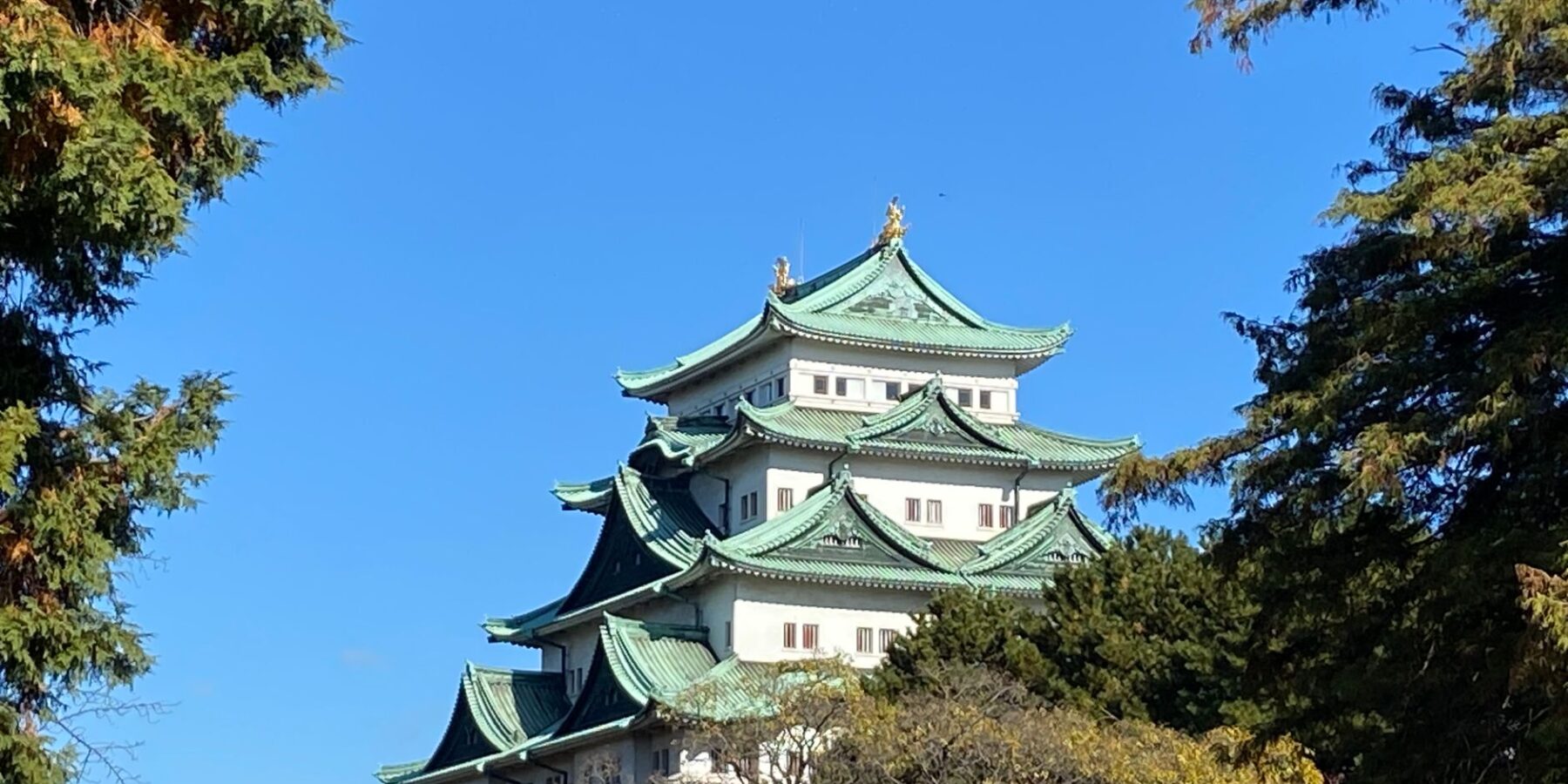 Nagoya Castle with green copper roofs under a blue sky in Aichi, Japan