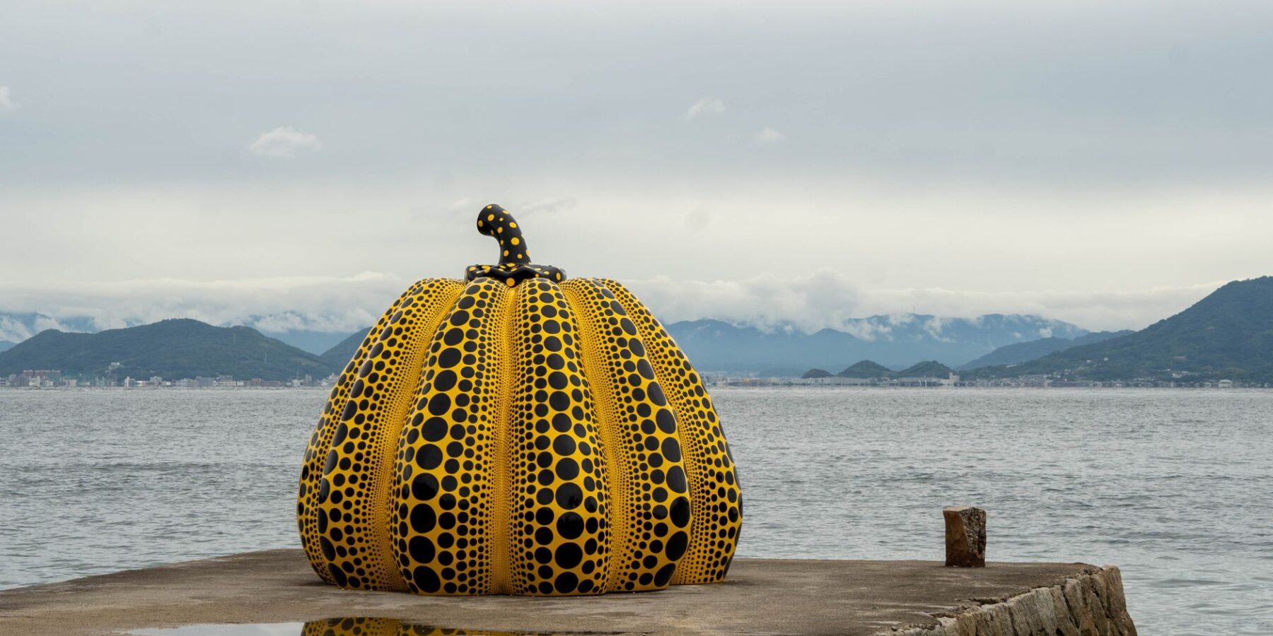 Yayoi Kusama yellow pumpkin sculpture on the pier at Naoshima, Kagawa, Japan