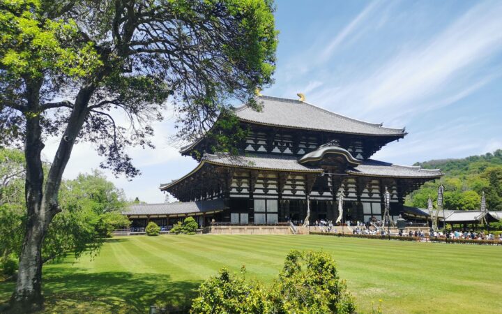 Todaiji Temple Great Buddha Hall behind green lawns in Nara, Japan