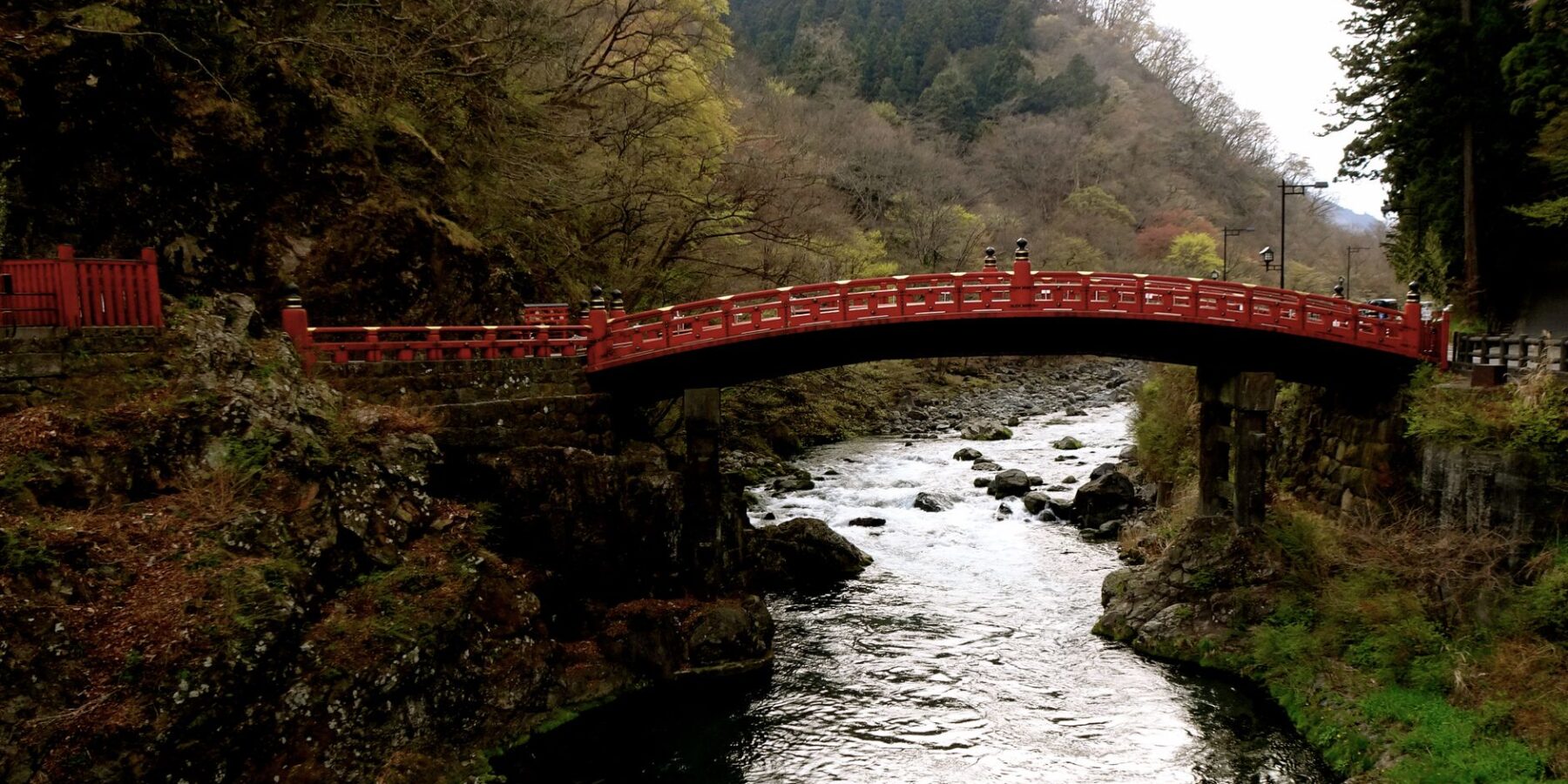 Red Shinkyo Bridge over the Daiya River surrounded by forest in Nikko, Tochigi, Japan