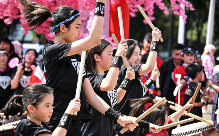 Young taiko drummers performing at an outdoor festival in Japan