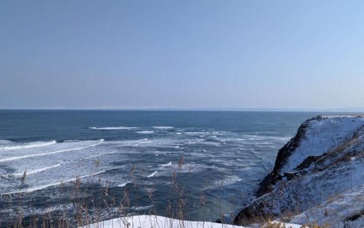 Snowy cliffs and rough winter sea at Cape Shiretoko, Hokkaido
