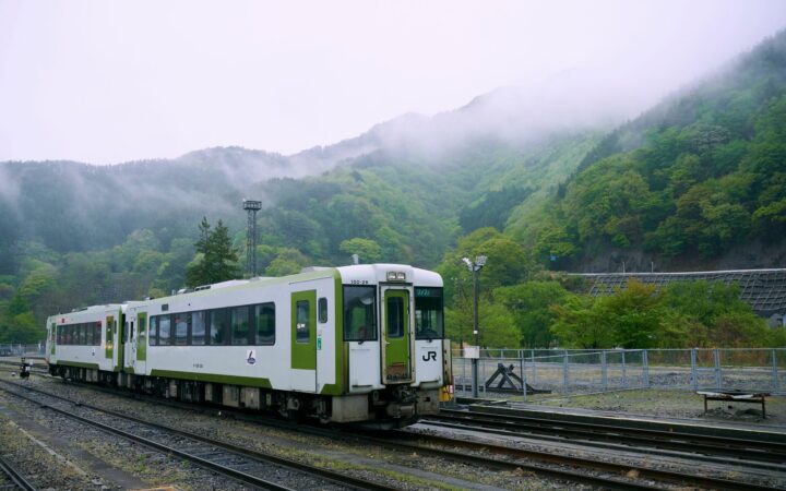 JR local train at a station among misty green mountains in Kamaishi, Iwate Prefecture