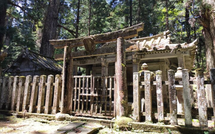 Moss-covered stone gate of an old mausoleum in the Koyasan forest, Wakayama
